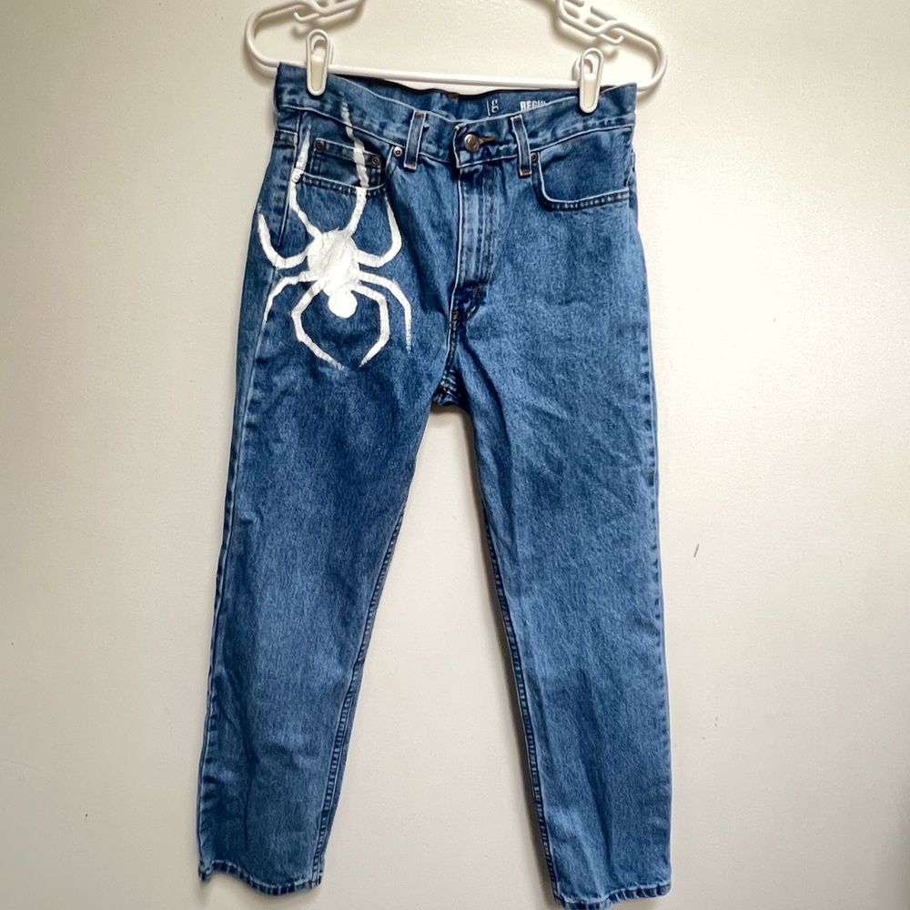 Blue denim jeans with spider print
